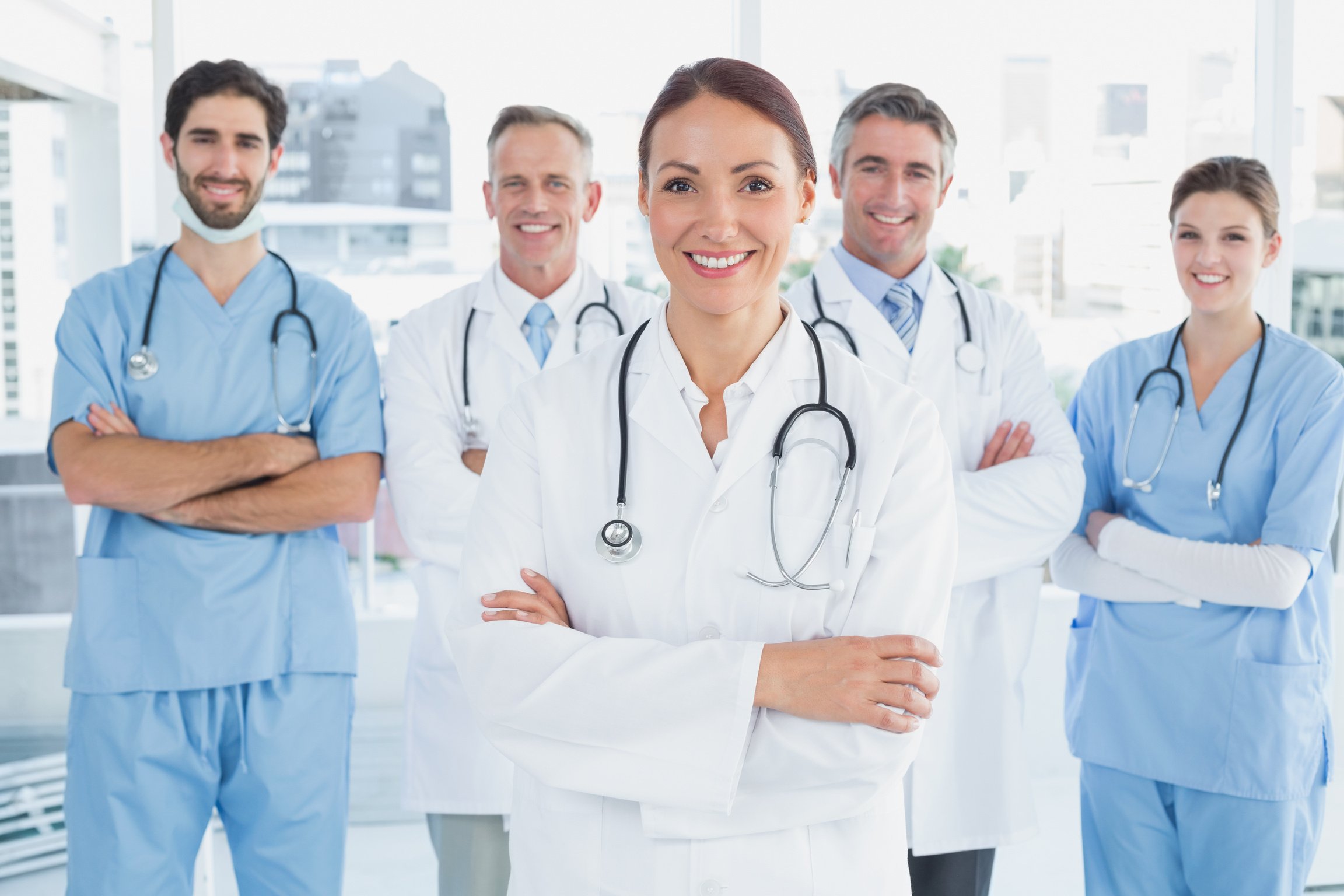 Smiling doctor with fellow doctors